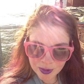 color photo of a woman with pink sunglasses and purple lipstick